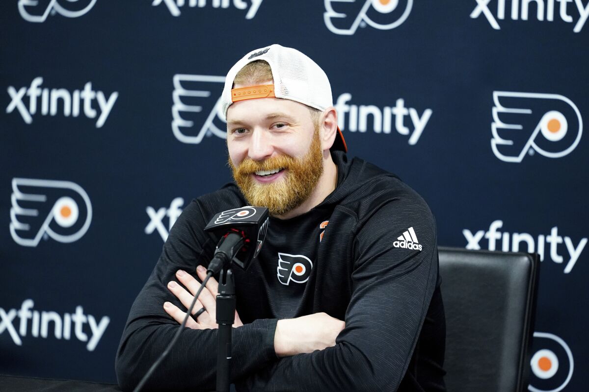 Philadelphia Flyers' Claude Giroux speaks with members of the media during a news conference at the team's NHL hockey practice facility, Wednesday, March 16, 2022 in Voorhees, N.J. Giroux's 1,000th career game with the Flyers on Thursday night could be his last in orange-and-black for the 34-year-old center approaching the final months of his contract. (AP Photo/Matt Rourke)