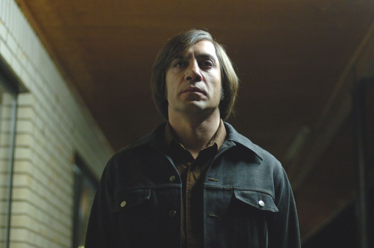 Javier Bardem stares straight ahead in a scene from “No Country for Old Men”