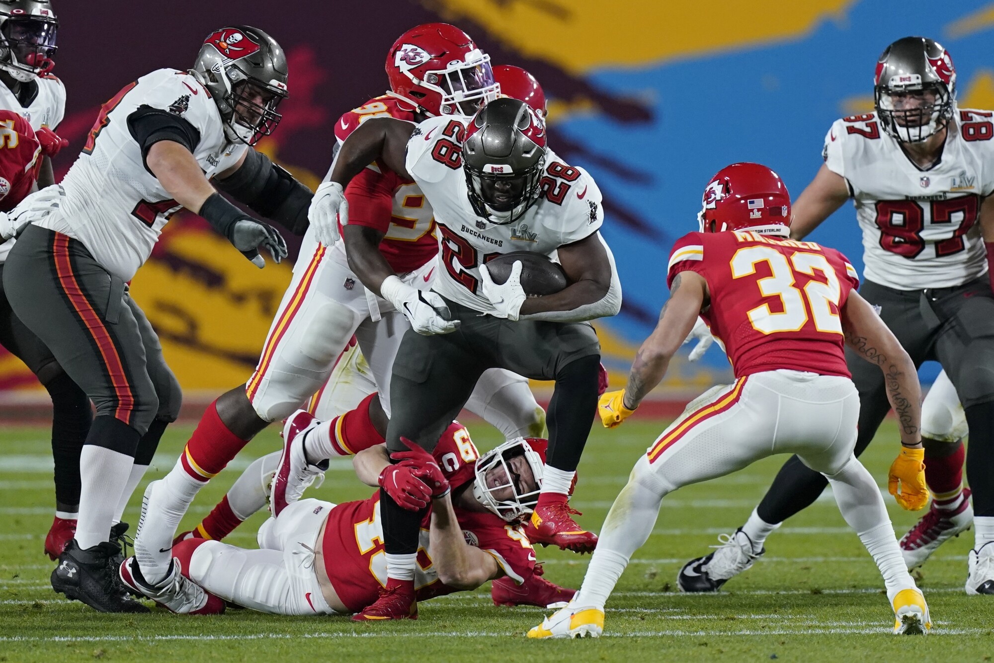 Kansas City Chiefs safety Daniel Sorensen grabs the leg of Tampa Bay Buccaneers running back Leonard Fournette.