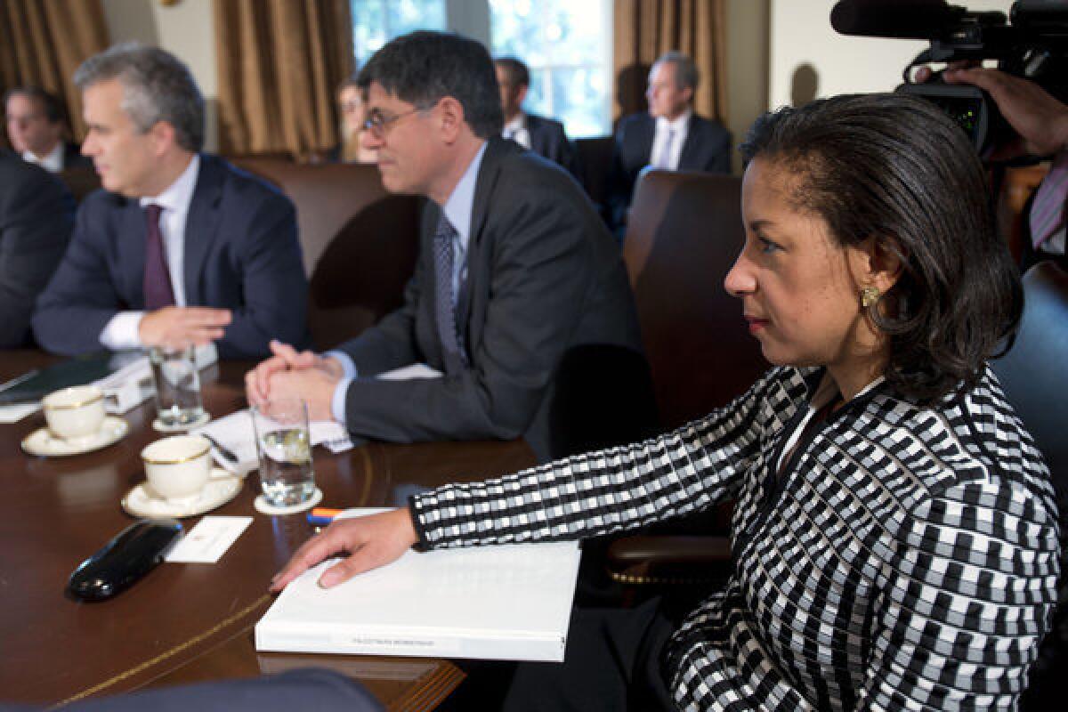 U.N. Ambassador Susan Rice listens, at right, as President Barack Obama speaks before a meeting with his cabinet at the White House in Washington.
