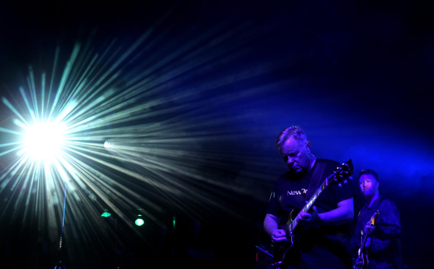Guitarist-singer Bernard Sumner, left, fronts New Order during a performance at the Greek Theatre in Los Angeles.