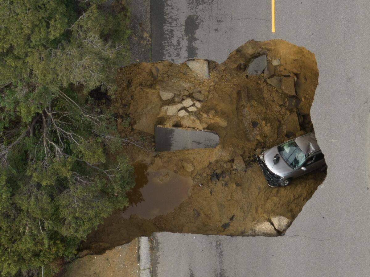 Two vehicles fell into a sinkhole on Iverson Road in Chatsworth trapping four people.