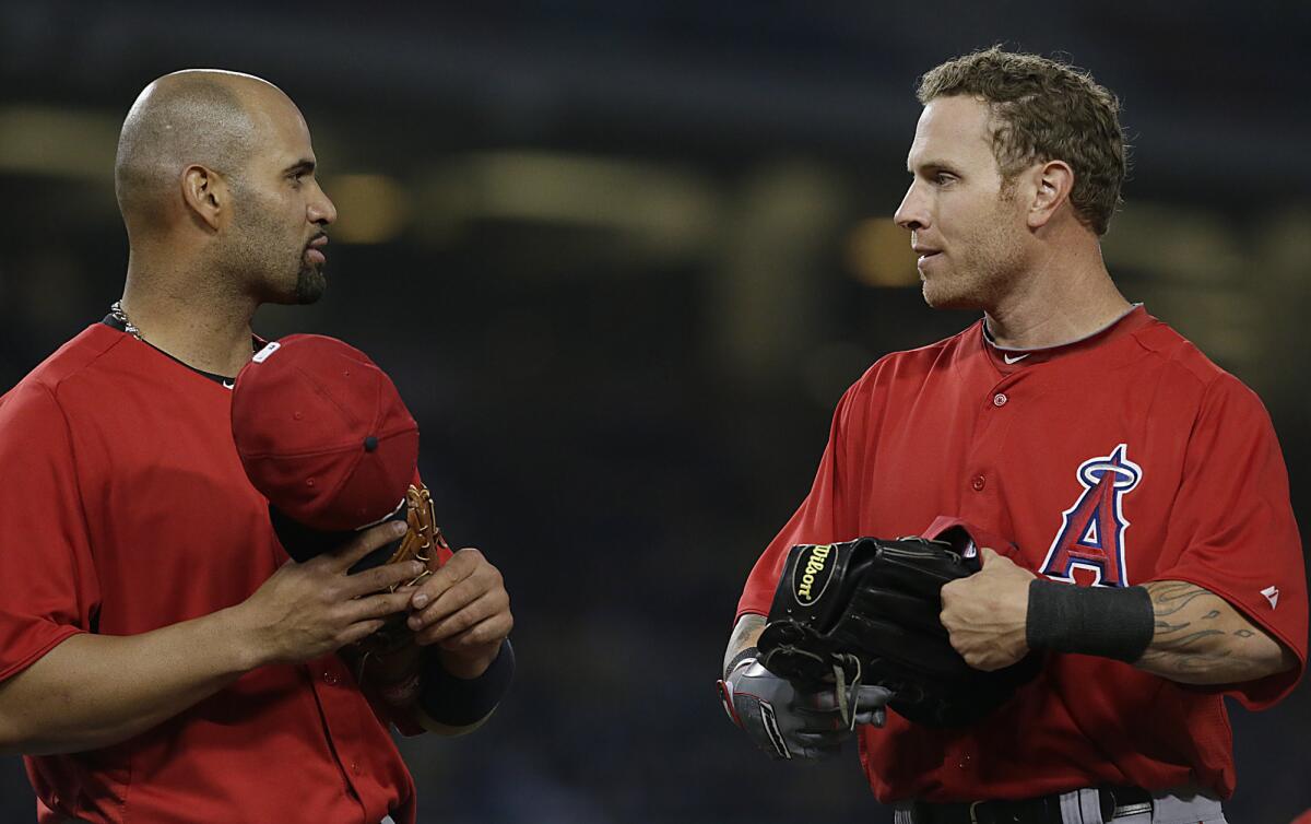 Albert Pujols, left, and Josh Hamilton chat between innings back in March 2013.