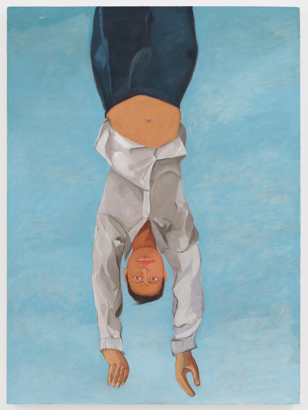 A large painting shows a man in a white shirt hanging upside down against a sky blue background
