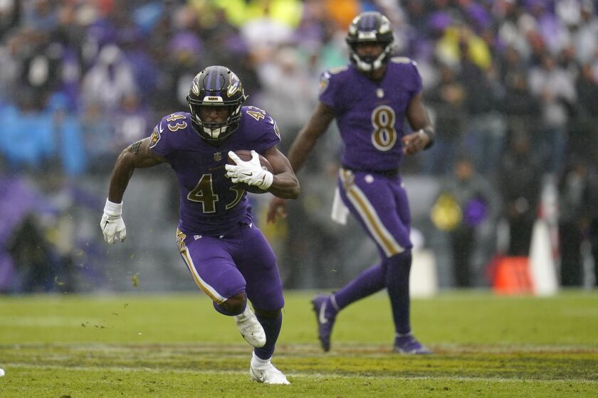 Baltimore Ravens running back Justice Hill (43) carries the ball against the Buffalo Bills in the second half of an NFL football game Sunday, Oct. 2, 2022, in Baltimore. (AP Photo/Julio Cortez)