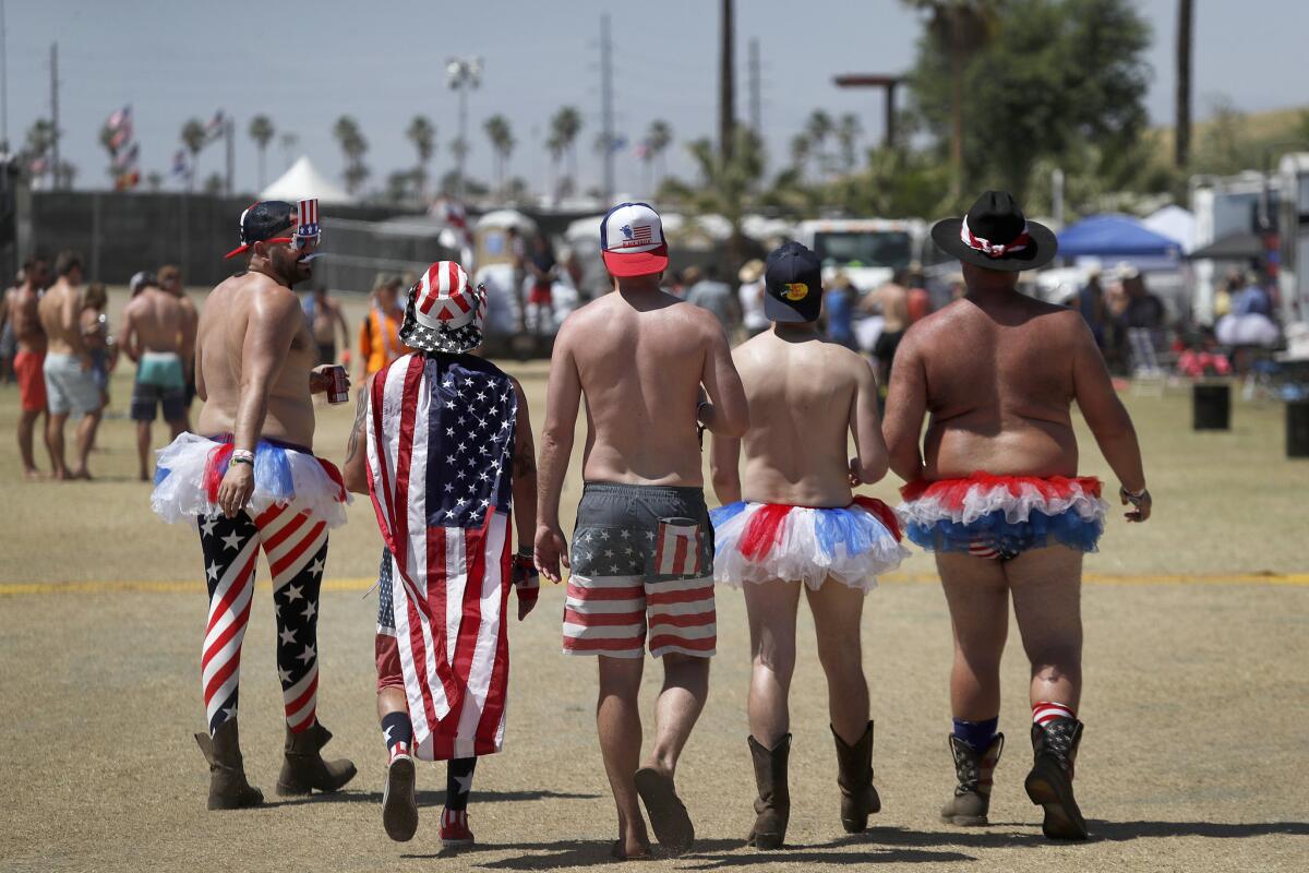 Men parade around the RV resort area Saturday supporting the spirit of USA.