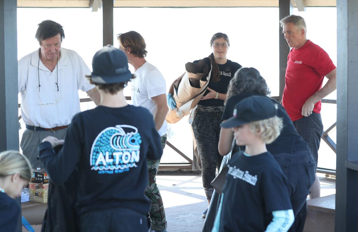 Volunteers clean up after painting portions of the Heisler Park gazebo during the Love Laguna Beach event.