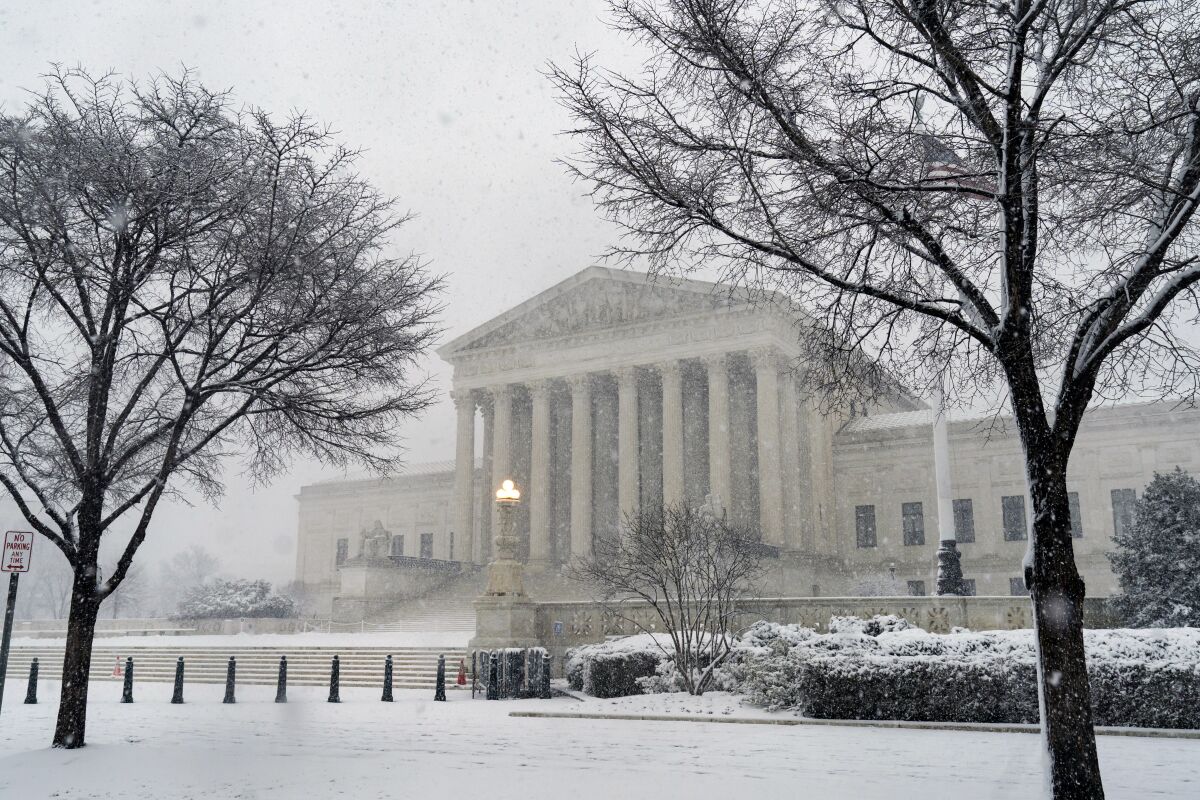 The Supreme Court is seen as a winter storm delivers heavy snow to Capitol Hill in Washington, Monday, Jan. 3, 2022. (AP Photo/J. Scott Applewhite)