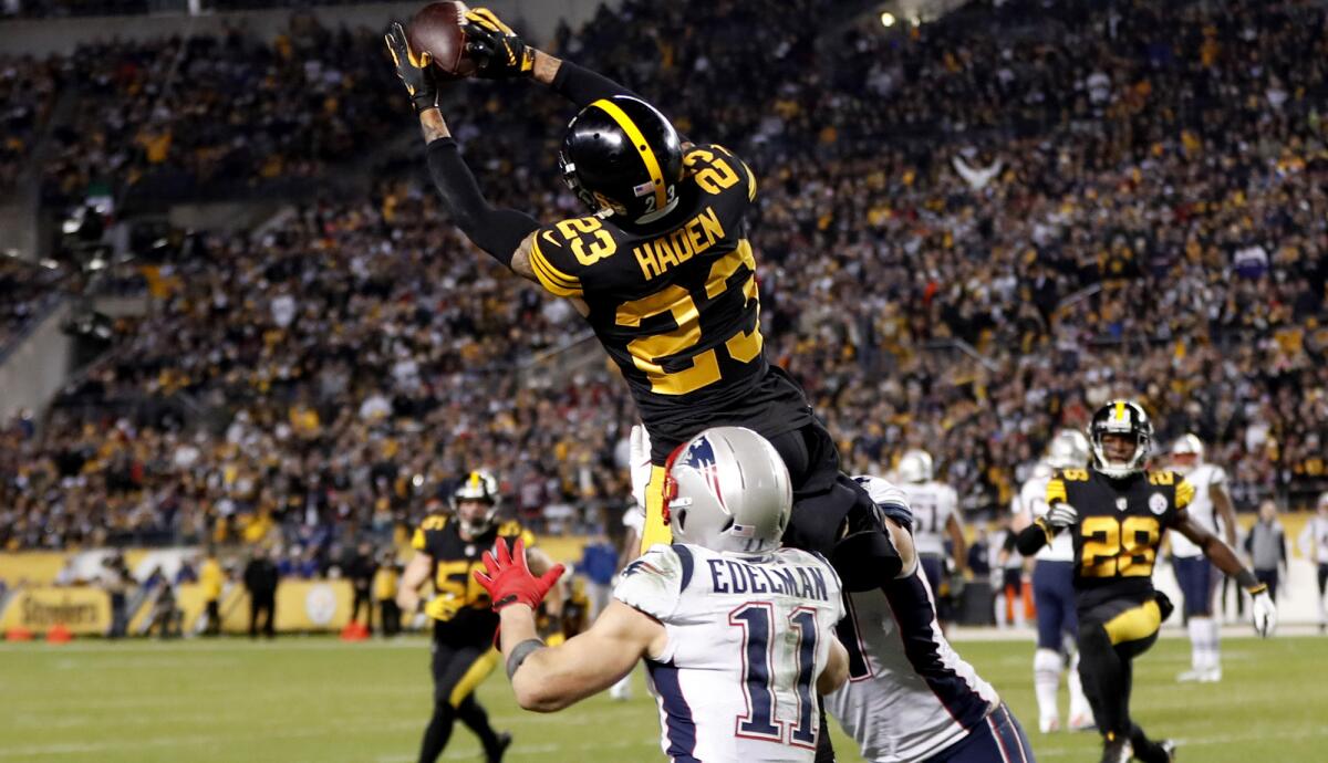 Steelers cornerback Joe Haden (23) intercepts a pass intended for Patriots wide receiver Julian Edelman during the second half Sunday.