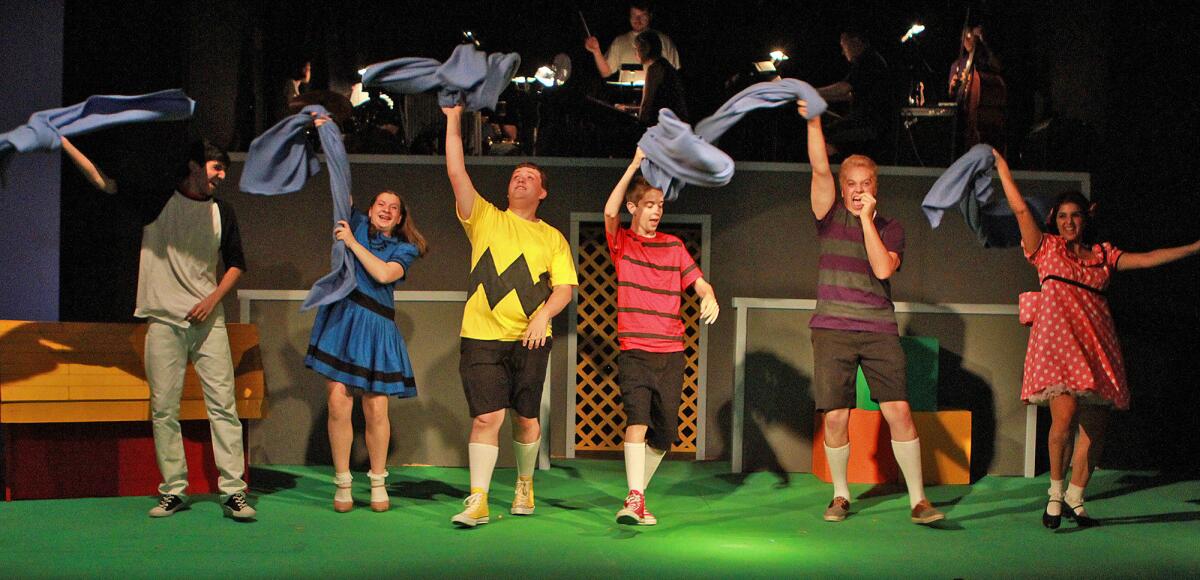 The youth cast, of Snoopy, played by Tim Byers, Lucy, played by Maddie Seifert, Charlie Brown, played by Miles Gonzalez, Linus, layed by Matt Bond, Schroeder, played by Billy McGavin, and Sally, played by Mackenzie Byers, dance in the "My Blanket and Me" scene at a dress rehearsal for the play "You're A Good Man, Charlie Brown", a production by the Stepping Stone Players, on Thursday, July 31, 2014 in the Little Theater at Hoover High School. The show opens on Friday.