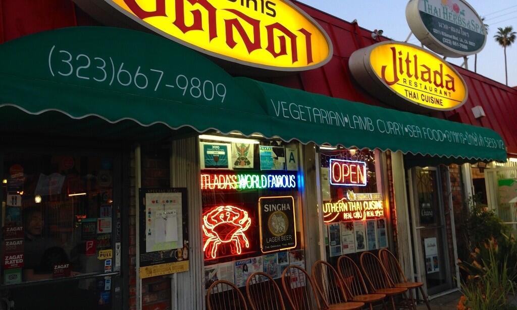 The Jitlada storefront in a Hollywood strip mall. The restaurant fills up quickly on a typical night, and parking can be hard to find. Outside, a row of chairs is set up for waiting customers.