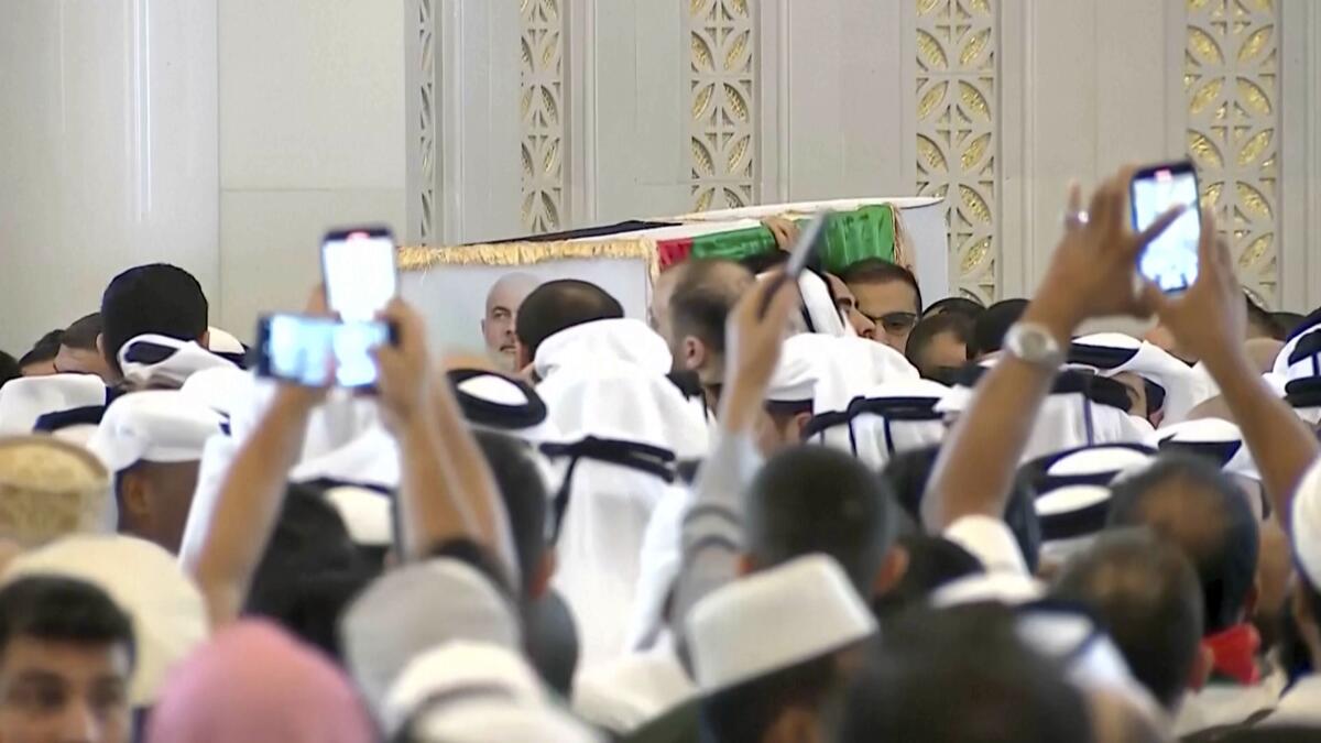 A coffin is carried amid mourners in Doha, Qatar.