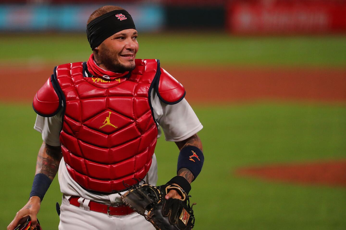 Download Yadier Molina of the St. Louis Cardinals delivers a pitch  Wallpaper