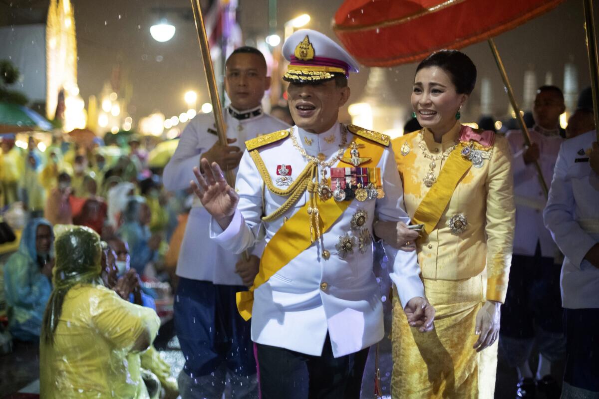 Thai King Maha Vajiralongkorn and Queen Suthida outside Bangkok's Grand Palace.