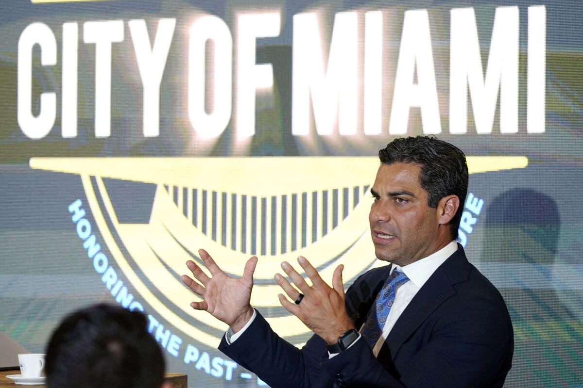 FILE — Miami Mayor Francis Suarez hosts a talk with local artists at the Bakehouse Art Complex, on the emergence of non-fungible tokens (NFTs) in the art world, July 27, 2021, in Miami, Fla. A small but well-publicized group of cryptocurrency enthusiasts called City Coins, is asking Miami and New York to accept the equivalent of millions of dollars in a new cryptocurrency scheme that has political leaders in other cities clamoring to get in on the deal. (AP Photo/Lynne Sladky. File)