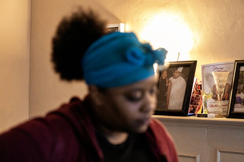 LOS ANGELES, CA - JANUARY 29: Tatiana Jackson, sister of Anthony Lowe, a disabled man who was shot by police officers in Los Angeles gather with family at her mothers home where Lowe lived on Sunday, Jan. 29, 2023 in Los Angeles, CA. A photo of Lowe sits on the fireplace mantel(Jason Armond / Los Angeles Times)
