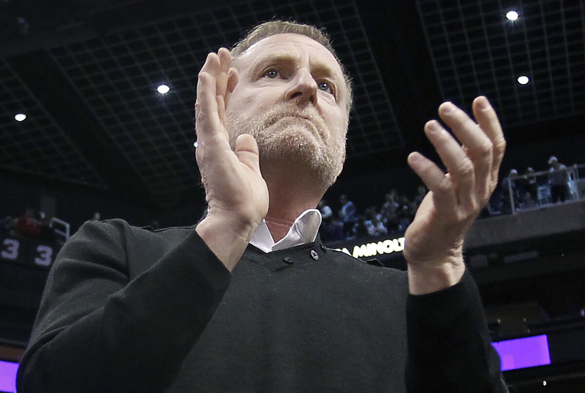 Phoenix Suns owner Robert Sarver applauds the team's 107-99 victory against the Minnesota Timberwolves