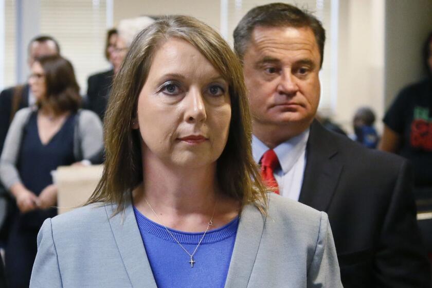 FILE - In this Wednesday, May 17, 2017 file photo, Betty Shelby leaves the courtroom with her husband, Dave Shelby, right, after the jury in her case began deliberations in Tulsa, Okla. The Department of Justice says there is insufficient evidence to pursue federal civil rights charges against the white former Tulsa police officer who shot and killed an unarmed black man. U.S. Attorney Trent Shores on Friday, March 1, 2019, announced the closure of the federal investigation into whether ex-Tulsa police officer Betty Shelby willfully used unreasonable force against Terence Crutcher when she shot and killed him in September 2016. (AP Photo/Sue Ogrocki, File)
