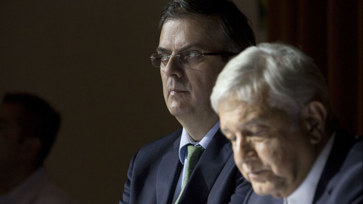 Former Mexico City Mayor Marcelo Ebrard attends a news conference with Mexican President-elect Andres Manuel Lopez Obrador, right, in their nation's capital on July 5, 2018.