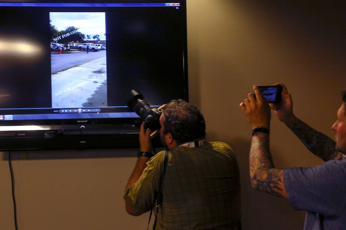 Photographers capture views of the police shooting video during a press conference at the El Cajon Police Department.