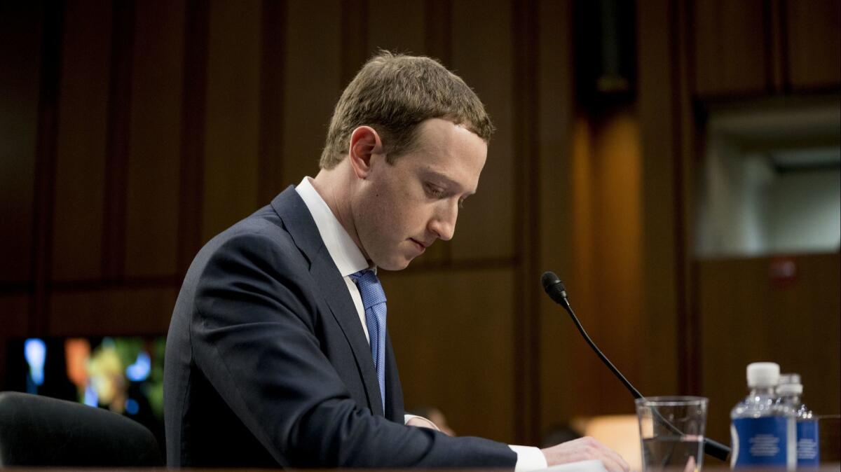 Facebook CEO Mark Zuckerberg pauses while testifying before a joint hearing of the Commerce and Judiciary committees on Capitol Hill in Washington about the use of Facebook data to target American voters in the 2016 election.