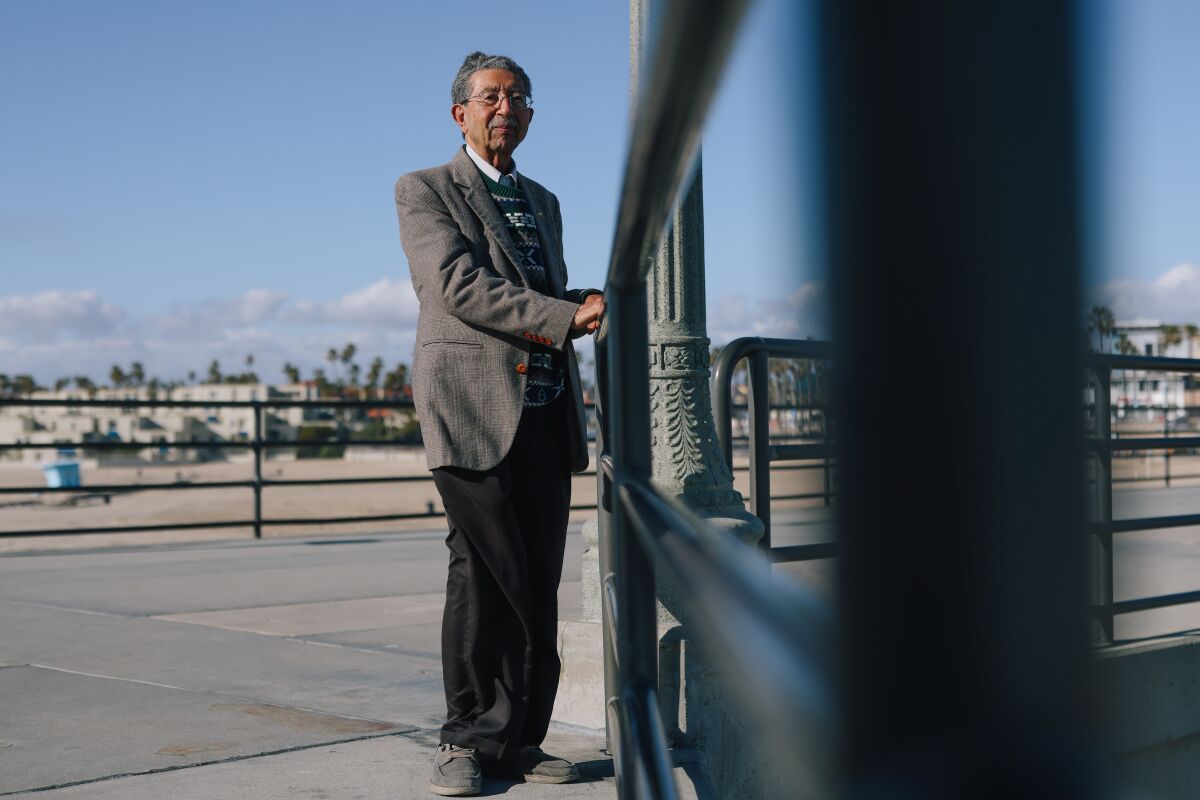 Maneck Bhujwala stands for a portrait on the Huntington Beach Pier