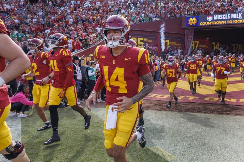USC quarterback Jayden Maiava runs out to the field with his teammates before playing Notre Dame on Nov. 30.