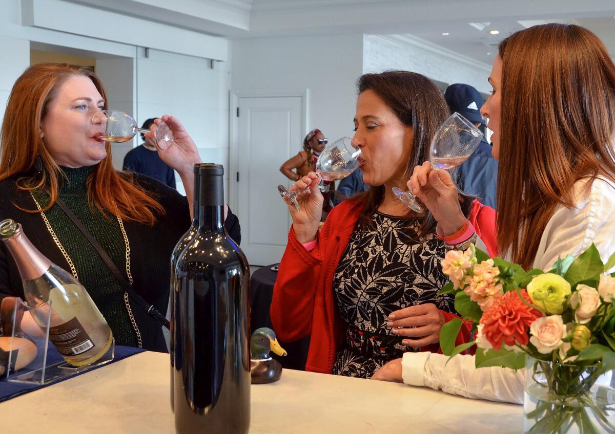 From left, Carolyn Barrett, Ellen Norris and Julia Dupps sample wine.