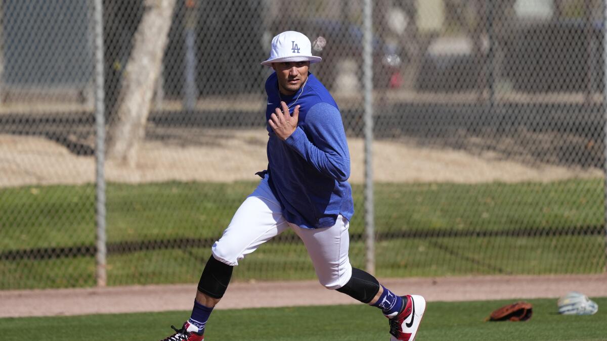Los Angeles Dodgers catcher Austin Barnes runs with all his catcher's gear  to a practice field during a spring training baseball practice Tuesday,  Feb. 23, 2021, in Phoenix. (AP Photo/Ross D. Franklin