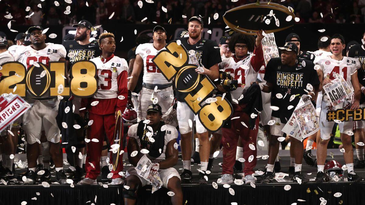 The Alabama football team celebrates beating Georgia in overtime and winning the College Football Playoff national championship on Monday.