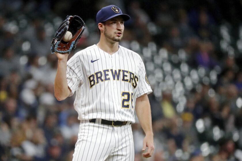 Milwaukee Brewers starting pitcher Aaron Ashby reacts after giving up a two-run home run to Miami Marlins' Peyton Burdick during the third inning of a baseball game, Saturday, Oct. 1, 2022, in Milwaukee. (AP Photo/Jon Durr)