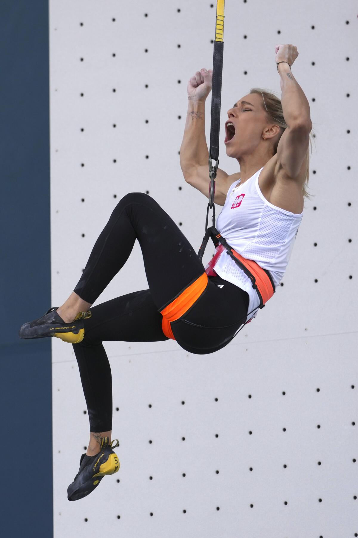 Aleksandra Miroslaw of Poland celebrates after competing in the women's speed climbing semifinals.