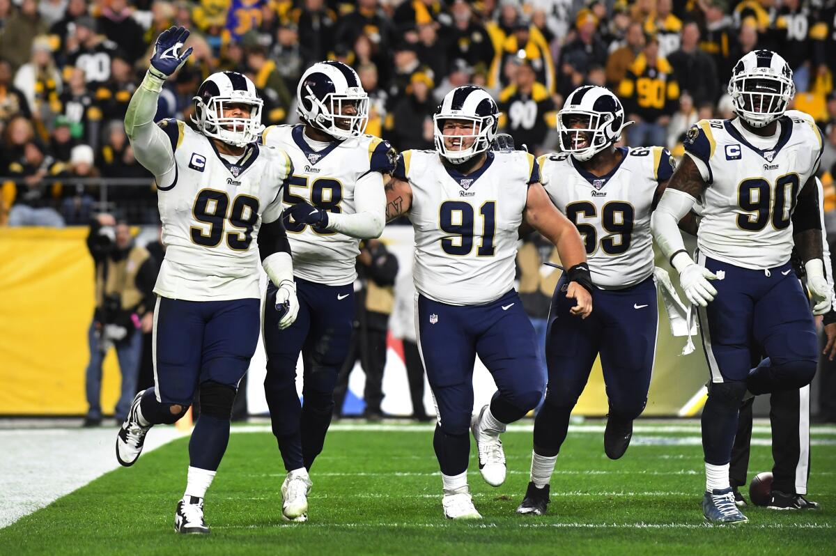 Aaron Donald (99) celebrates with the Rams defense after sacking Steelers quarterback Mason Rudolph in the end zone for a safety during a game Nov. 19.