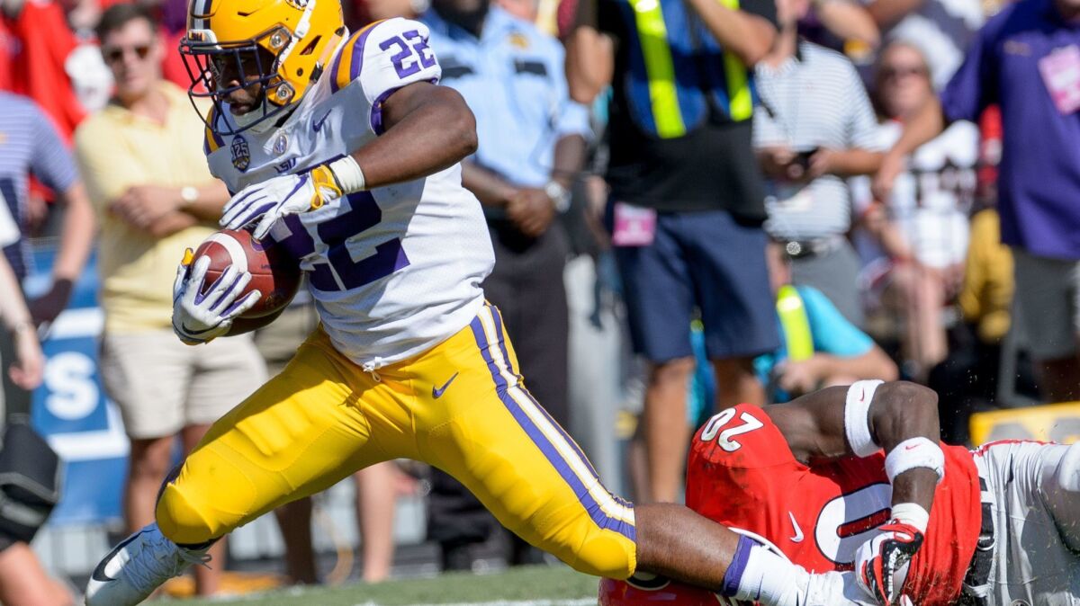 LSU running back Clyde Edwards-Helaire (22) runs against Georgia defensive back J.R. Reed (20) during a game in Baton Rouge, La., on Saturday.
