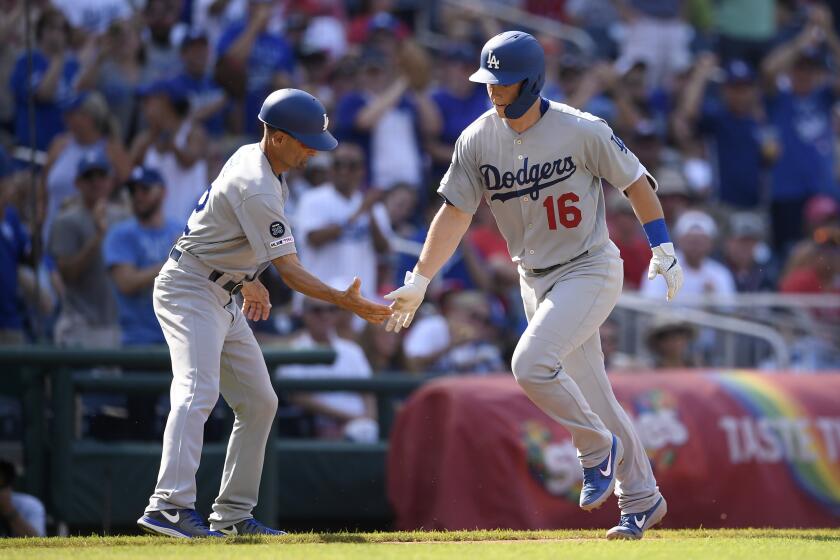 Los Angeles Dodgers' Will Smith (16) is greeted by third base coach Dino Ebel, left, as he rounds the bases after his home run during the third inning of a baseball game against the Washington Nationals, Saturday, July 27, 2019, in Washington. (AP Photo/Nick Wass)