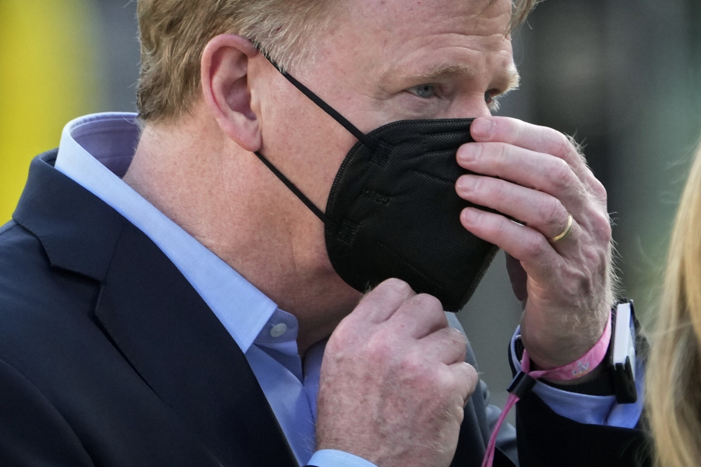 NFL commissioner Roger Goodell adjusts his face mask before Super Bowl LV