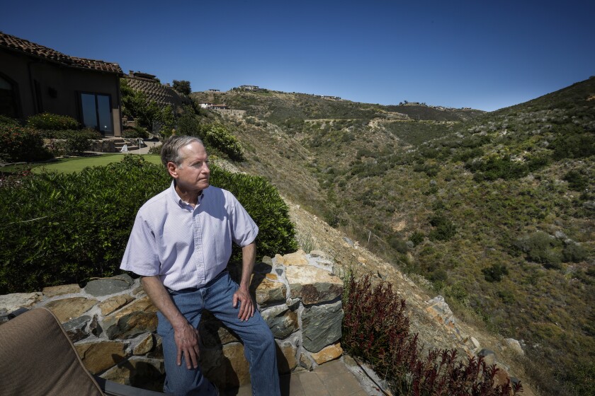 Stan Caplan looks out from the back yard of his home, on July 10, 2019, in Rancho Santa Fe, California, which overlooks a canyon. After four years, his insurance company has canceled his homeowner's policy because of the threat of wildfire.