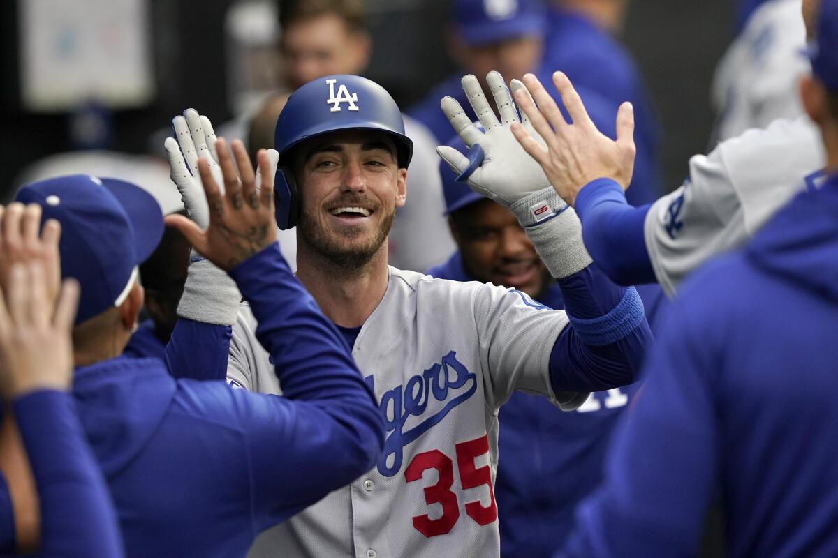 Dodgers' Cody Bellinger is congratulated in the dugout for his home run off Chicago White Sox pitcher Johnny Cueto.