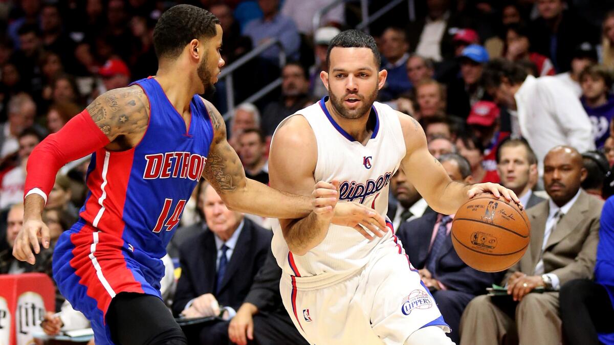 Clippers guard Jordan Farmar, right, tries to drive past Detroit Pistons guard D.J. Augustin during the Clippers' 113-91 win at Staples Center on Monday.