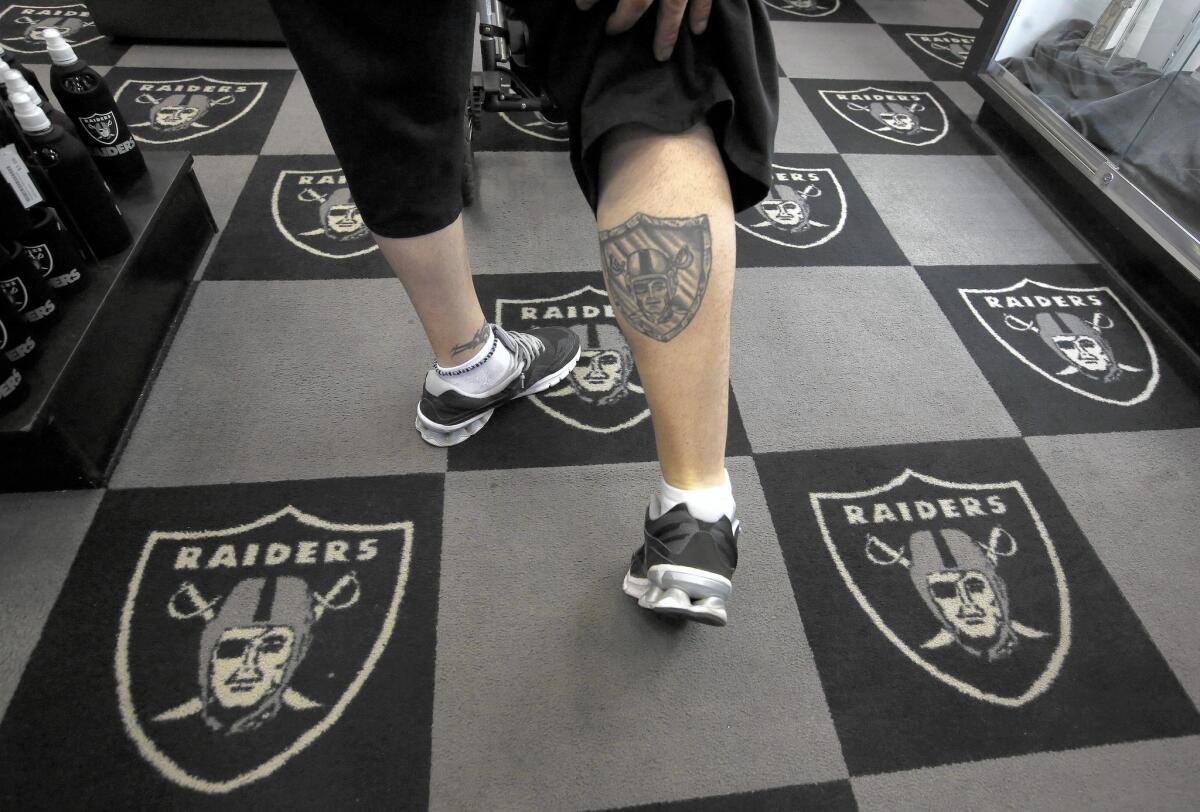 Al Romero of Salt Lake City shows off his Raiders tattoo during a visit to the Raider Image store.