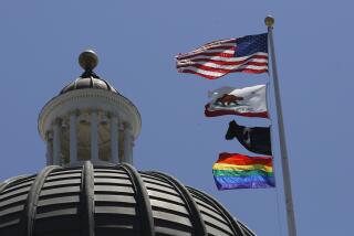 The rainbow Pride flag flutters from the flag pole at the state Capitol in Sacramento in June 2019.