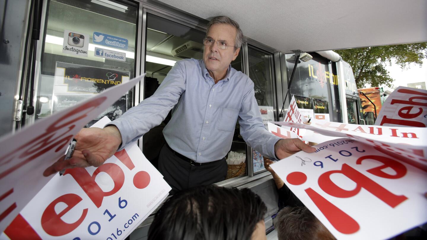 Former Florida Gov. Jeb Bush signs autographs from the window of a food truck after he formally announced that he would join the race for president with a speech at Miami Dade College on June 15.