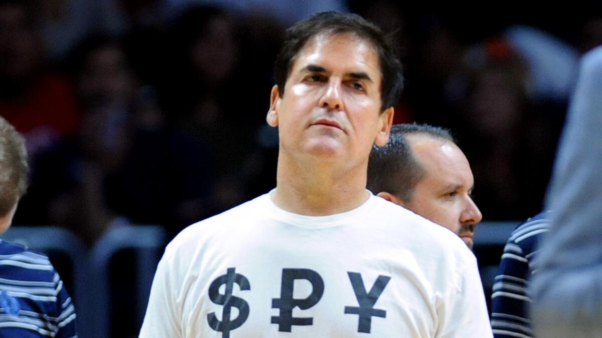 Mavericks owner Mark Cuban listens to a referee during a timeout at the Staples Center on Thursday night.