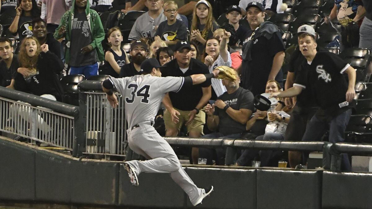 New York Yankees rookie Dustin Fowler tries to catch a foul ball hit by the Chicago White Sox's Jose Abreu on June 29.