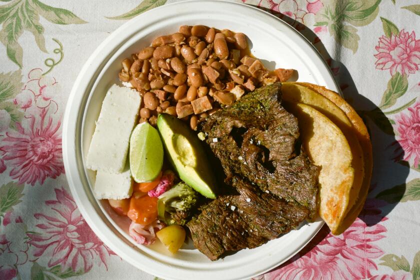 A plate featuring Frijoles Charros in Broth and Arrachera Verde, made by ASADA cookbook author Bricia Lopez at Debs Park.