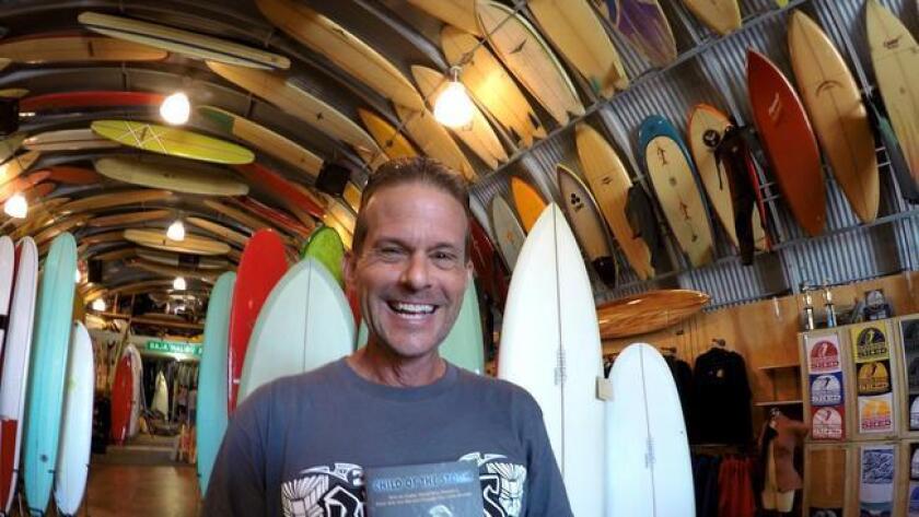 Kirk Aeder with his book at Bird's Surf Shed in San Diego.