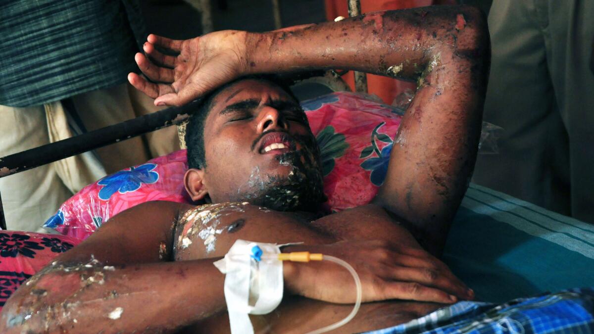 A survivor is treated at a hospital following a fire at the Paravur Puttingal Devi temple in Kerala on April 10.