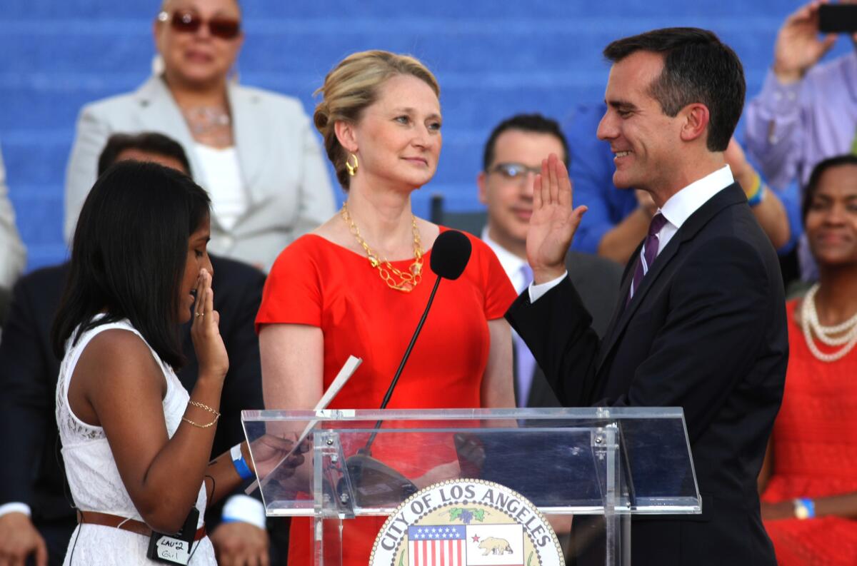 Eric Garcetti and wife, Amy Wakeland, center, during the mayor's swearing-in ceremony, plan to move to Getty House.