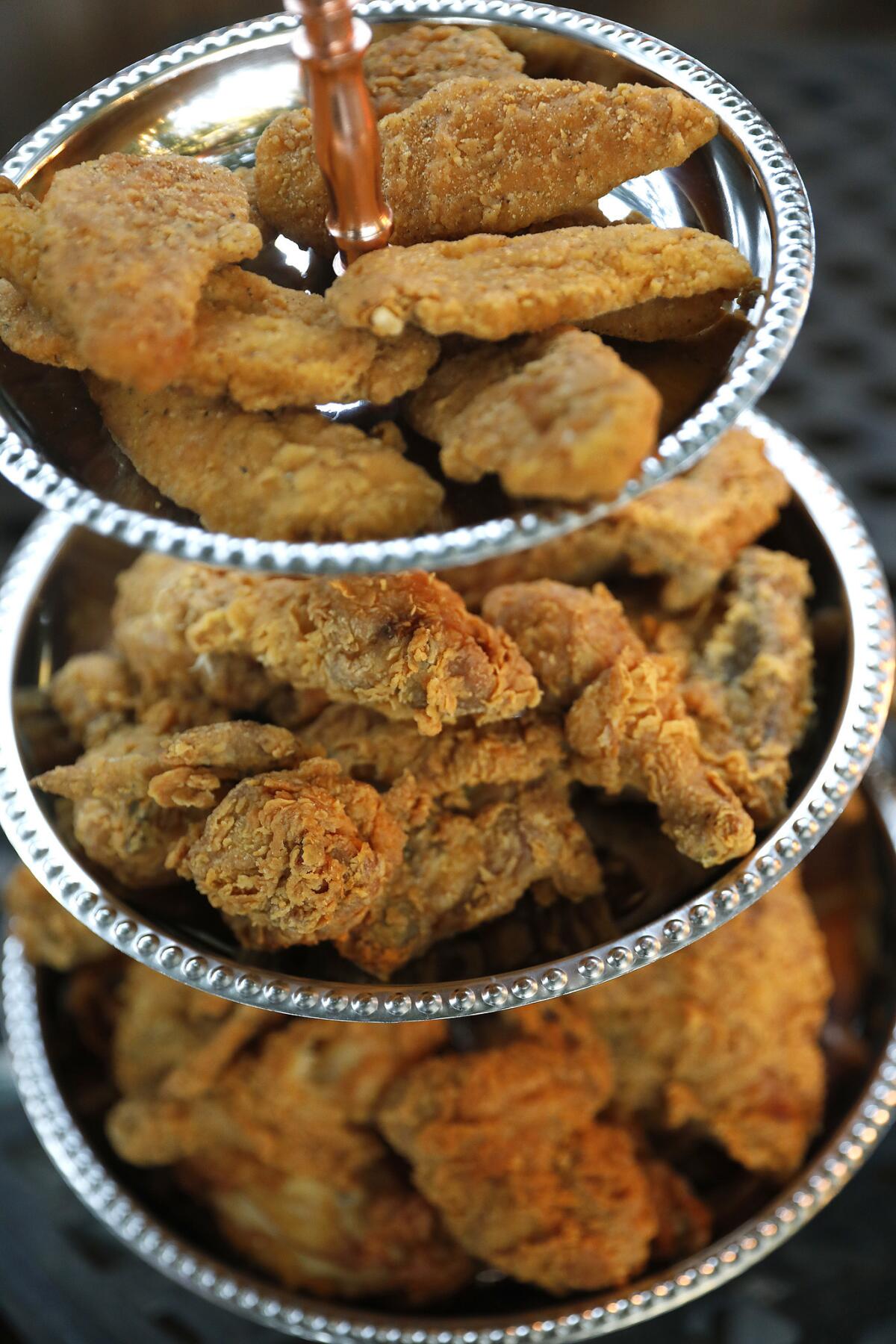 Three tiers of fried chicken for guests at a fried chicken party.