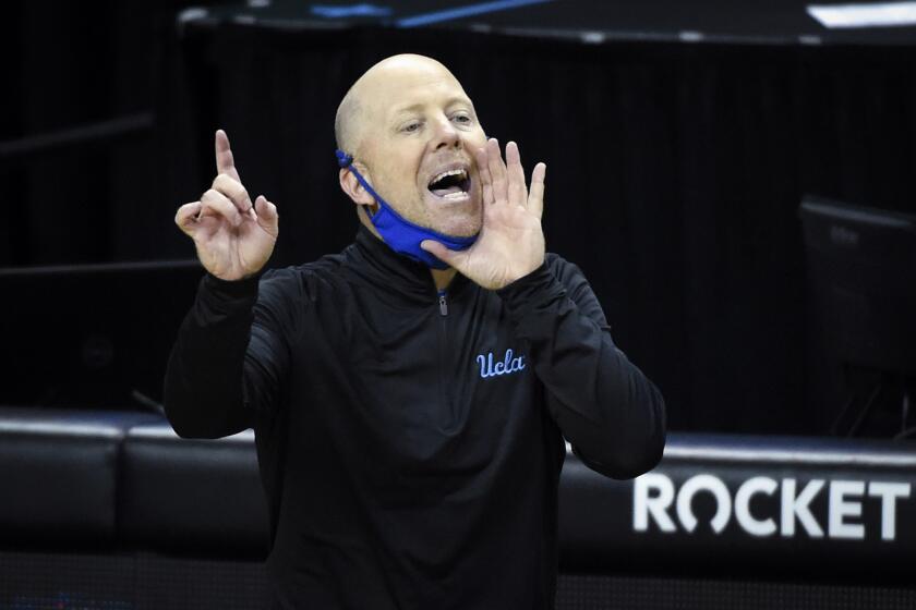 UCLA head coach Mick Cronin communicates with his team during the first half of an NCAA college basketball game Wedesday, March 3, 2021, in Eugene, Ore. (AP Photo/Andy Nelson)